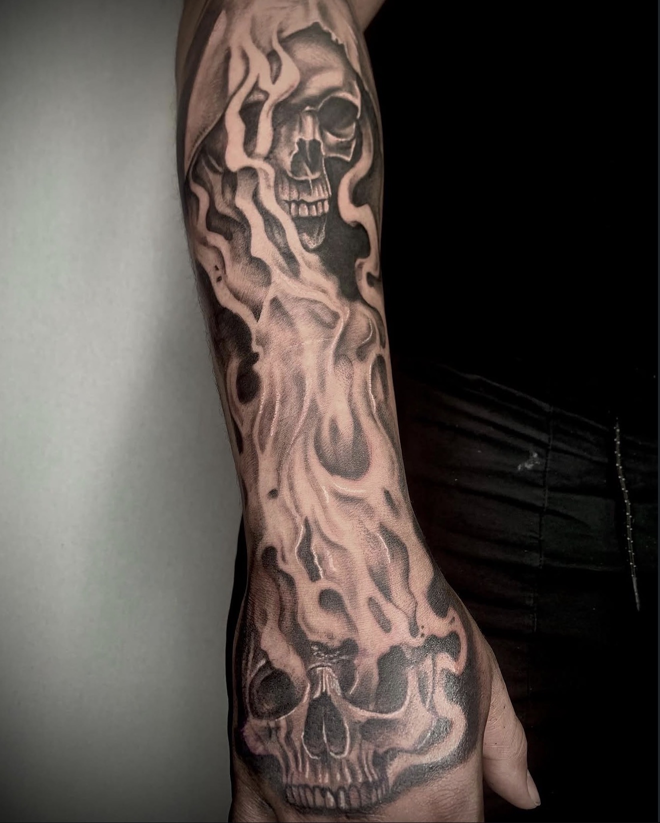 Flaming skulls, arm to hand